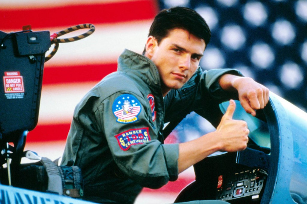 a young tom cruise from the 1980s posting for his Top Gun movie