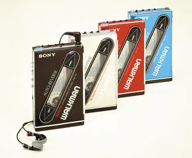vintage sony walman tape players in 4 different colors of red, blue, cream, and black.
